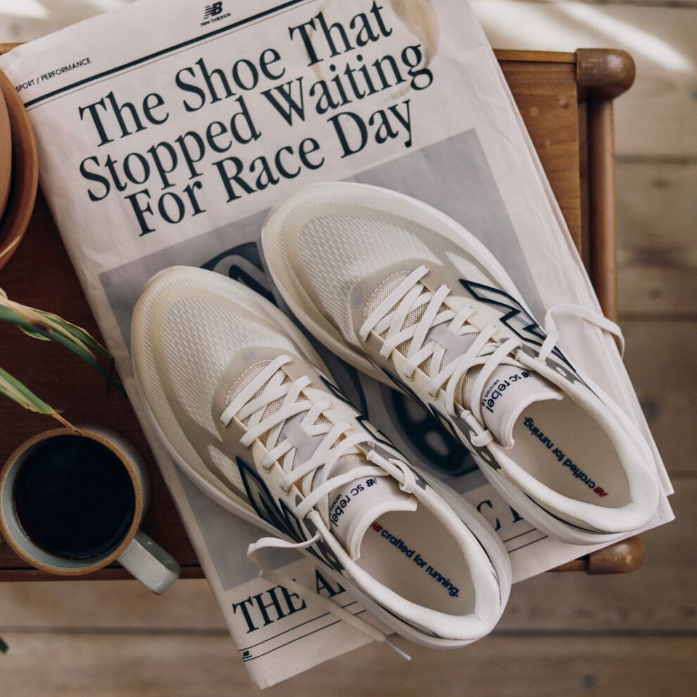 Overhead shot of New Balance running shoes placed on a newspaper.